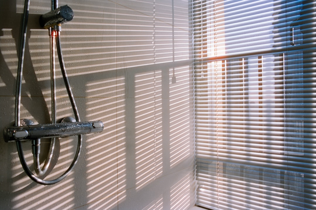 shower-faucet-with-striped-light-patterns-on-wall-zynogah8tag